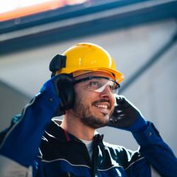 Smiling factory worker wearing hard hat