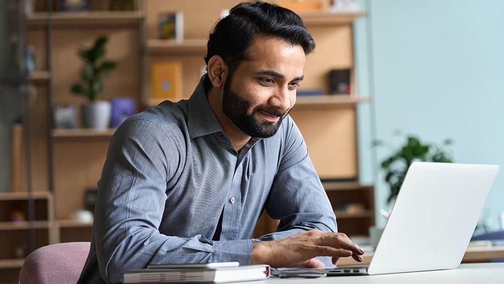 For only $180, get SAS certified and increase your earning potential Young businessman taking a certification exam on his laptop