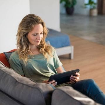 Woman watching media on tablet