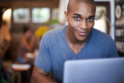 young man using his laptop in a coffee shop