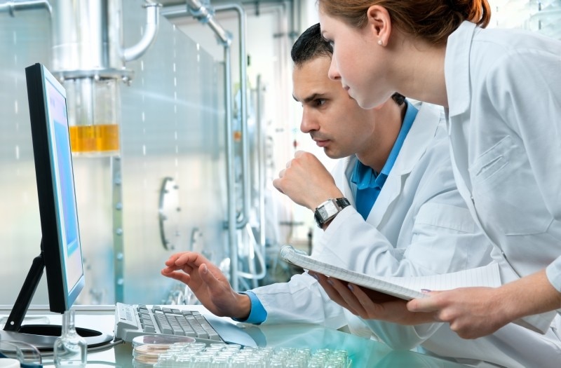 Two scientists review data lab