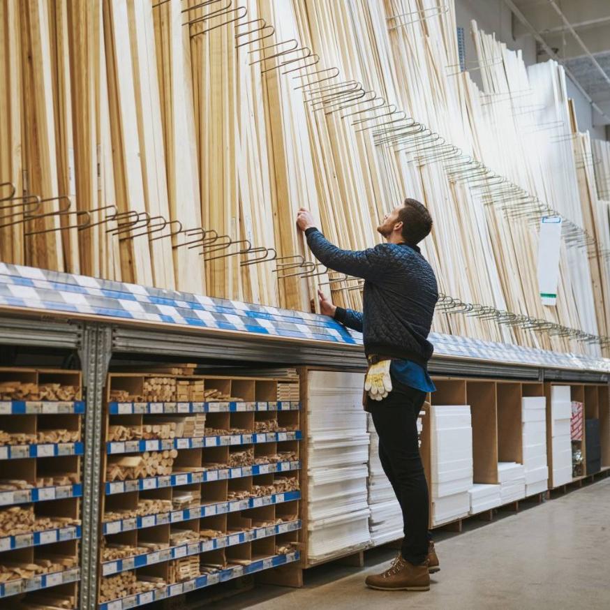 Man at hardware store selecting wood
