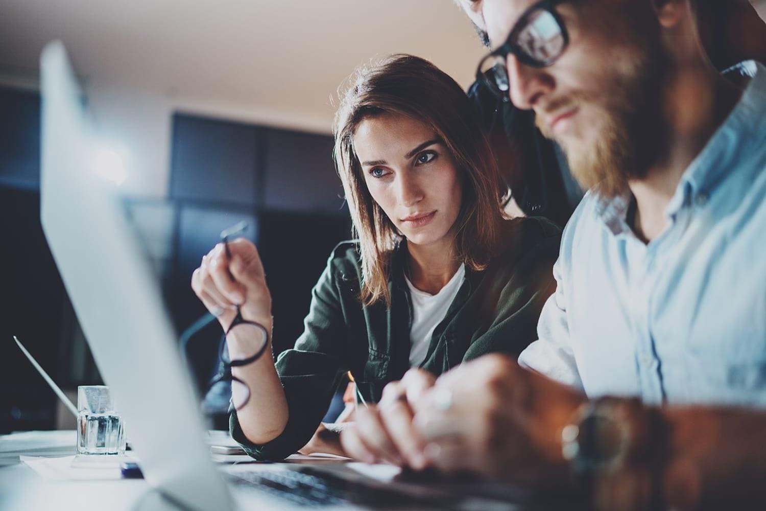Male and female coworkers working at a computer