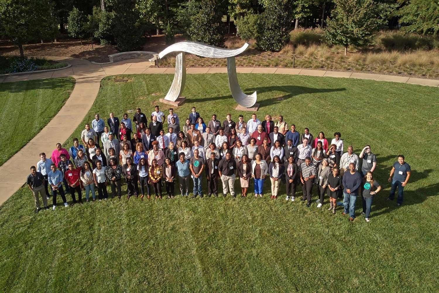 HBCU Initiatives at SAS Headquarters Group of SAS employees and interns on SAS headquarters lawn with large Pi sculpture behind them